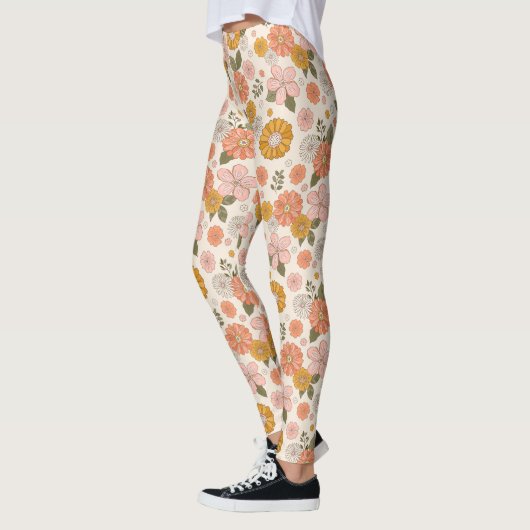 ピンクとオレンジの花園のパターン レギンス (左)