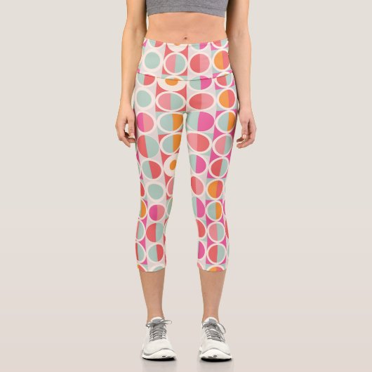 ピンクのオレンジ色の青い幾何学的パターン カプリレギンス (正面)