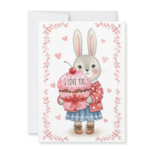 ピンクのカップケーキを持つかわいいウサギ