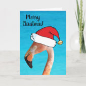 ピンクのフラミンゴが赤い漫画のサンタ帽子をかぶったクリスマス シーズンカード (正面)