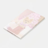 ピンクの弓のクリスマス写真を飾ったかわいい犬 ポストイット (アングル)