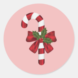 ピンクの背景にリボンとクリスマスホーリーが飾られたキャンディケイン ラウンドシール