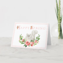 ピンクの花のイースターカードを持つ白猫
