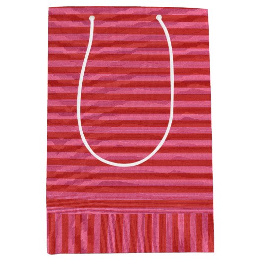 ピンクの赤ストライプいメリークリスマスと明るい ミディアムペーパーバッグ (正面)