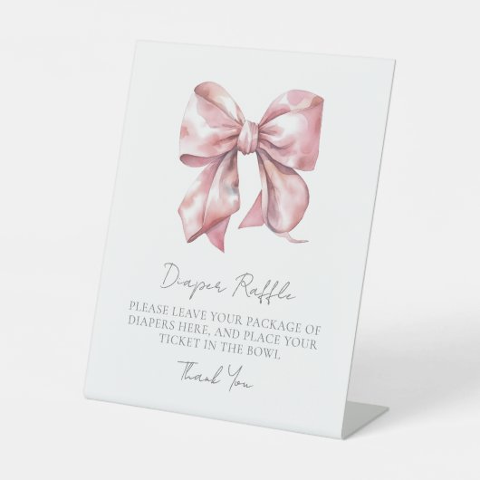 ピンクボウ赤ちゃんシャワーおむつラッフルエンクロージャカード 台座サイン (正面)