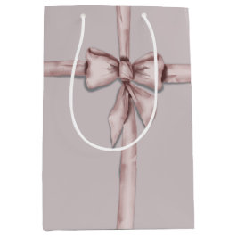 ピンク包まれたの弓で ミディアムペーパーバッグ