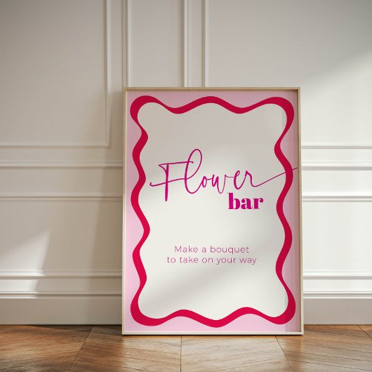ピンク縁どの波型バーが花束を引き立てる 台座サイン