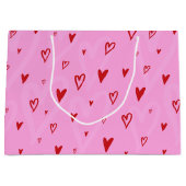 ピンク色の背景に可愛い赤いハート ラージペーパーバッグ (正面)