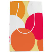 ピンク、オレンジ、黄色の水玉模様 ミディアムペーパーバッグ (正面)