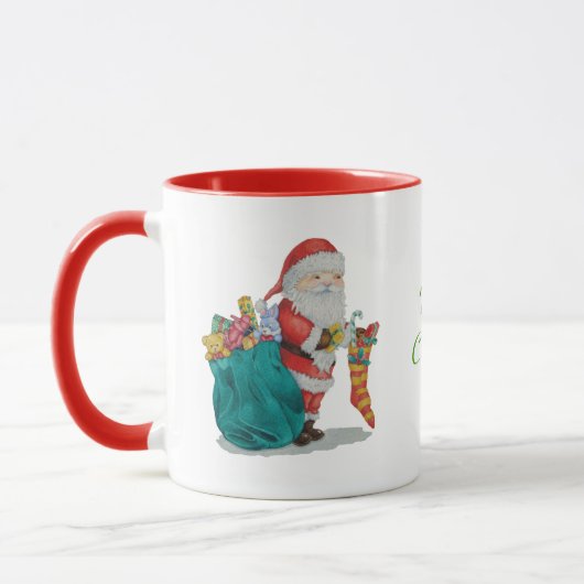 フェスティバルのデザインサンタとクリスマスのプレッシー マグカップ (左)