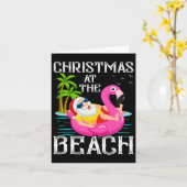 フラミンゴの浮き輪に乗ったサンタクロース ビーチのクリスマス カード (黄色い花)