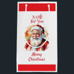 ブライトサンタクロースMerry Christmas Fatherクリスマス スモールペーパーバッグ<br><div class="desc">このフェスティバルしゃれているプレゼンテーションバッグでギフトに追加カラフル。サンタクロース図解入りの、写真付きのを水彩画のスタイルで取り上げた抱き枕は明るく明るくメリーなる。両サイドの一番上には「お土産」という言葉があり、サンタ写真の下には「メリークリスマス」という挨拶がある。背面には自分のカスタム文字でパーソナライズできるメッセージが表示される。</div>