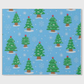 ブルーの背景に雪の降る緑のクリスマスツリー ラッピングペーパー (フラット)