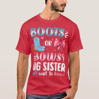ブーツまたは弓ビッグシスター性別が赤ちゃんシャワーを明らかにする Tシャツ