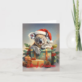 プレゼントとヒイラギを持つ幸せなクリスマスのコアラ シーズンカード