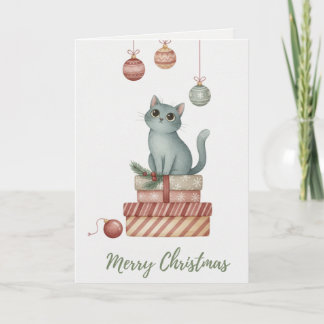 プレゼントの箱の上のクリスマスの子猫 カード