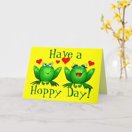 ホッとした日かわいいマンガのカエルを飼う カード (黄色い花)