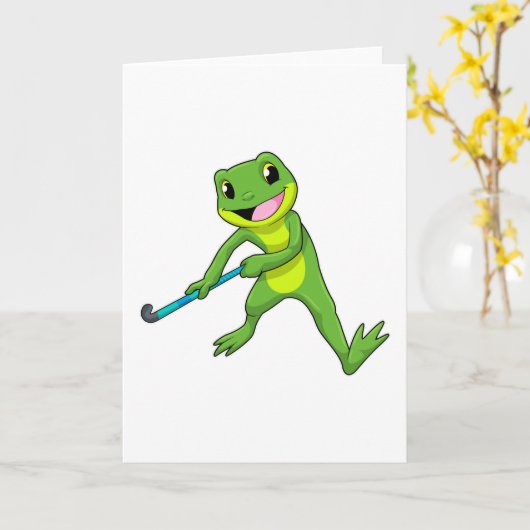 ホッケーでホッケーのスティックを持つカエル カード (黄色い花)
