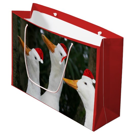 ホワイトダックおもしろいズインレッドサンタキャップスホリデー ラージペーパーバッグ (正面アングル)