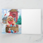 ポメラニアンの犬が雪のクリスマス犬小屋にいる カード (内部)