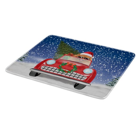 ポメラニア犬の犬が雪のクリスマスに車を運転 カッティングボード (角)