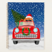 ポメラニア犬の犬が雪のクリスマスに車を運転 プランナー手帳 (正面)