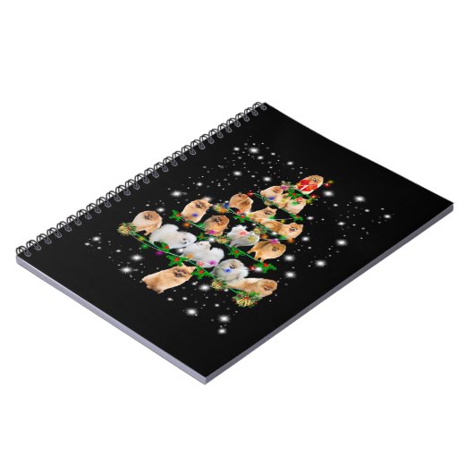 ポメラニア犬クリスマスツリーが懐中電灯で覆われている ノートブック (左側)