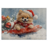 ポメラニア犬犬のソリで雪のクリスマス カッティングボード (正面)