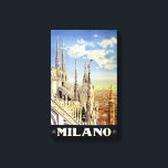 ミラノイタリアヴィンテージ旅行ポスター復元 キャンバスプリント<br><div class="desc">ミラノの街並みを超えて、大聖堂の屋根と尖塔を示す修復されたデジタル強化された旅行ポスター。不完全性の除去。色を修正。画像はLibrary of Congressの提供。</div>