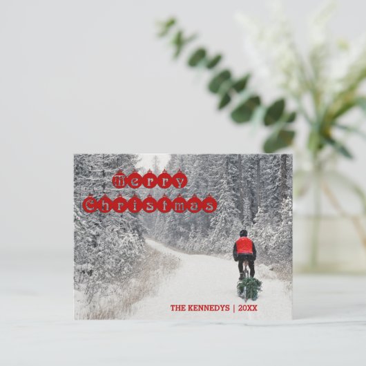 メリークリスマス – バイクもしくは自転車に乗る人が木を持ち帰る シーズンポストカード (スタンド正面)