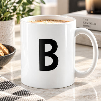 モダンなミニマリストモノグラムのイニシャルが大きくプリントされたブラックマグ コーヒーマグカップ