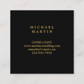 モノグラムが付いているエレガントな黒および金ゴールドの月桂樹のリース スクエア名刺 (裏面)