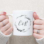 モノグラム フローラル リース ホワイト スクリプト ウェディング コーヒーマグカップ<br><div class="desc">このエレガントなウェディングマグは、繊細なカリグラフィーで描かれたミニマルなフローラルリースを美しくモノグラム化したイニシャルが特徴です。さわやかな白い背景にデザインは、シンプルさと優雅さを醸し出しており、特別な日のあなたにとって完璧な記念品となっています。控えめなフローラルリースはロマンチックなタッチを加え、パーソナライズされたモノグラムはユニークなものにしています。ウェディングギフトやカップルへの思いやりあるプレゼントとして理想的で、 新婚夫婦が一緒に朝のコーヒーを飲むのに最適な、愛と絆を象徴するタイムレスなマグカップです。</div>