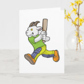 ヤギがクリケットのバットを持って打者として カード (黄色い花)