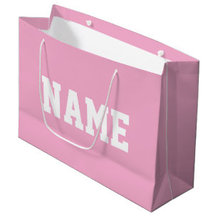 ライトベビーピンクの背景にホワイトのスポーツテキストを配置したアスリックデザイン YOUR NAME ラージペーパーバッグ