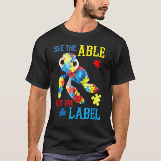 ラベルではなく能力を見る カメ パズル 自閉症 アウェアネス Tシャツ (正面)