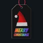 レッド・サンタハットのレインボー文字で「MERRY CHRISTMAS!」 ギフトタグ<br><div class="desc">このおもしろいクリスマスプレゼントラベルデザインは、カラフルのレインボースペクトル勾配パターンを持つ文字を持つ「MERRY CHRISTMAS!」というメッセージを特徴とする。赤いサンタの帽子の表現も特徴。</div>