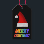 レッド・サンタハットのレインボー文字で「MERRY CHRISTMAS!」 ギフトタグ<br><div class="desc">このおもしろいクリスマスプレゼントラベルデザインは、カラフルのレインボースペクトル勾配パターンを持つ文字を持つ「MERRY CHRISTMAS!」というメッセージを特徴とする。赤いサンタの帽子の表現も特徴。</div>