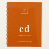 ロゴ燃えオレンジ色のモノグラムイニシャルビジネス2025 プランナー手帳 (正面)