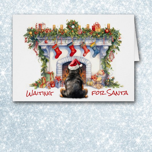 ロットワイラー犬がサンタクリスマス暖炉を待つ