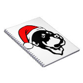 ロットワイラー犬が赤いクリスマスサンタハットを着て ノートブック (右側)