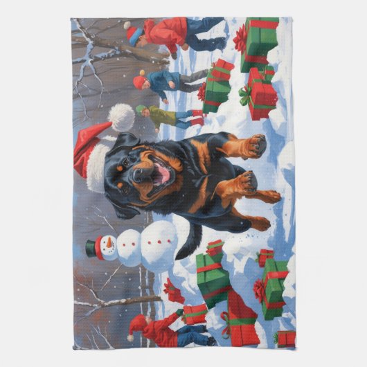 ロットワイラー走のクリスマス帽子と雪の中 キッチンタオル (縦)