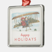 ヴィンテージのクリスマスのヒイラギのかわいい子供の飛行機の休日 メタルオーナメント (左)