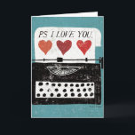 ヴィンテージデスクトップ – Typewriter カード<br><div class="desc">© Michael Mullan / Wild Apple青い背景を持つ古い白黒のタイプライター。PS I Loveという言葉がイメージに映る。</div>