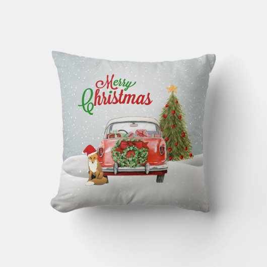 ヴィンテージ車はクリスマスツリーおよび孤のsittiによって駐車しました クッション (正面)