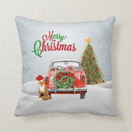 ヴィンテージ車はクリスマスツリーおよび孤のsittiによって駐車しました クッション