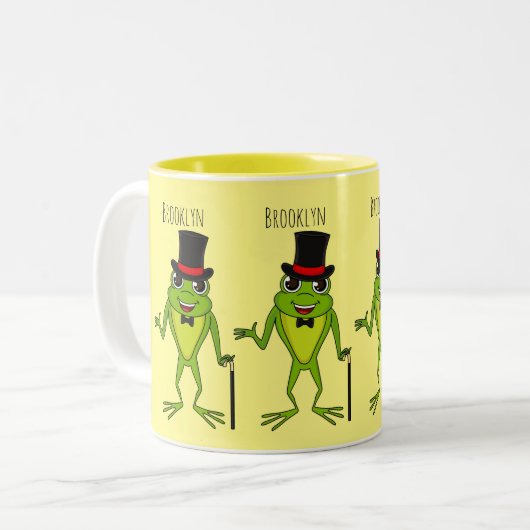 上おもしろい帽子漫画のカエル ツートーンマグカップ (正面左)