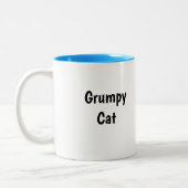 不機嫌な猫のマグカップ ツートーンマグカップ (左)