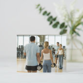 人の前で手の重さを持ち上げる男女 ポストカード (スタンド正面)