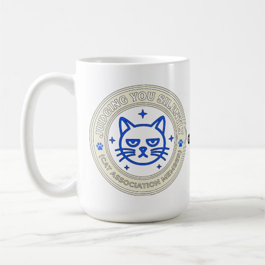 公式ネコ協会 会員 あなたを黙って見てる コーヒーマグカップ (左)